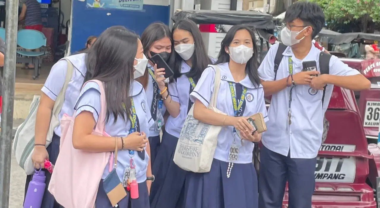 Students wearing face masks and uniforms.