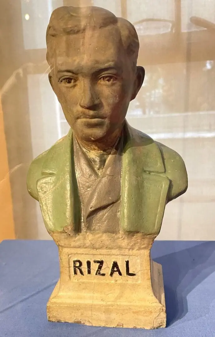 A bust of rizal is displayed on the table.