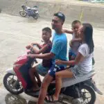 A man and three children on a motorcycle.