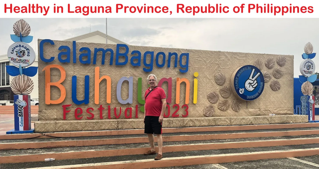 A man standing in front of a sign for the guam bagong buhayani festival.