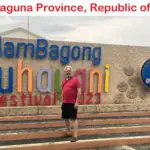 A man standing in front of a sign for the guam bagong buhainimi festival.