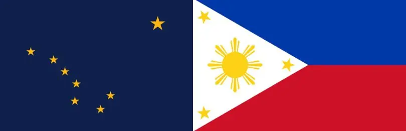 A flag of the philippines with a star and sun on it.