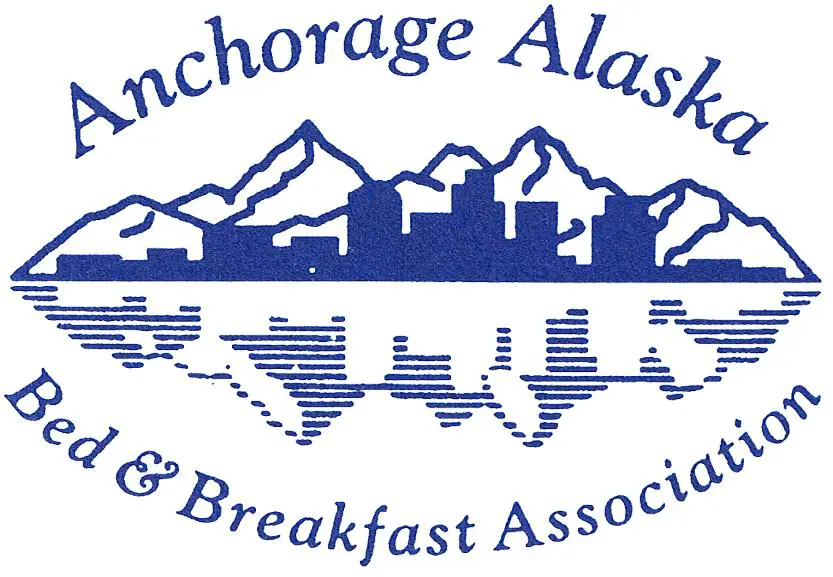 A blue and white logo for the anchorage alaska hotel & breakfast association.