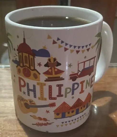 A coffee mug with the word philippines written on it.