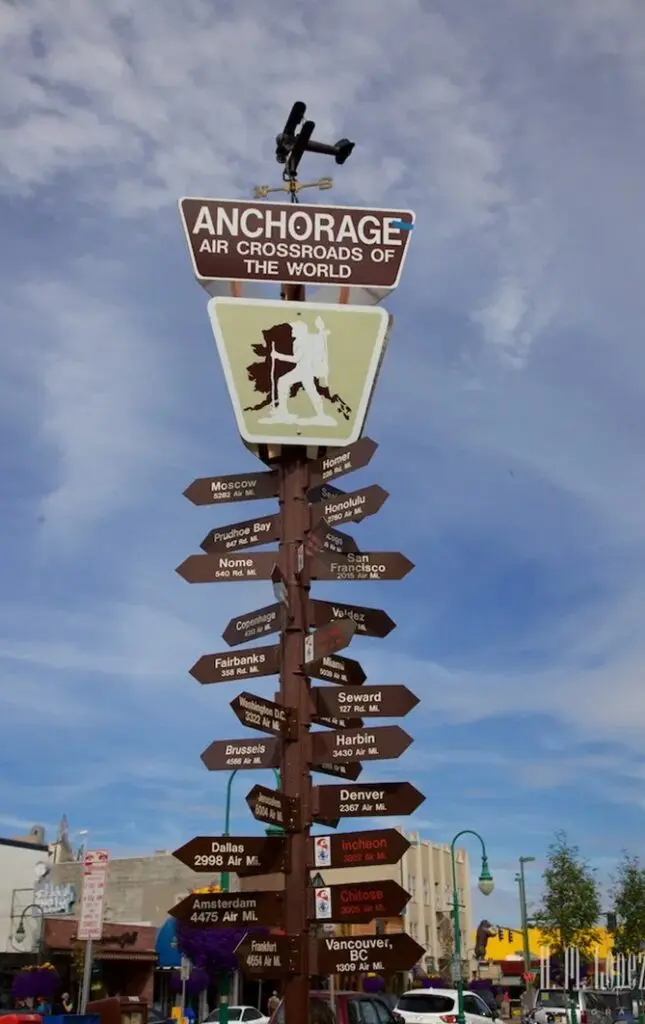 A pole with many different signs on it