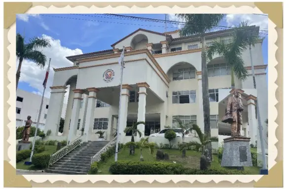 Government building with statues and palm trees.