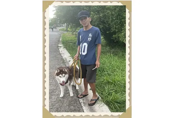 Person walking a dog on a path.