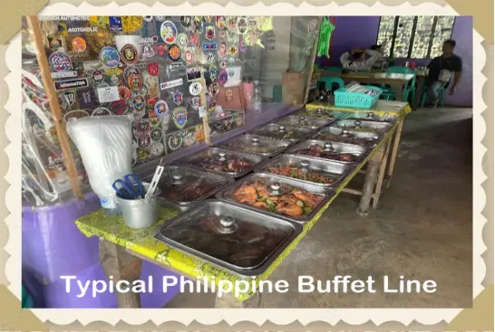 Typical Philippine buffet with various food dishes.