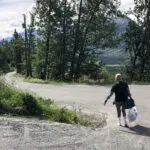 Person walking down a winding road.