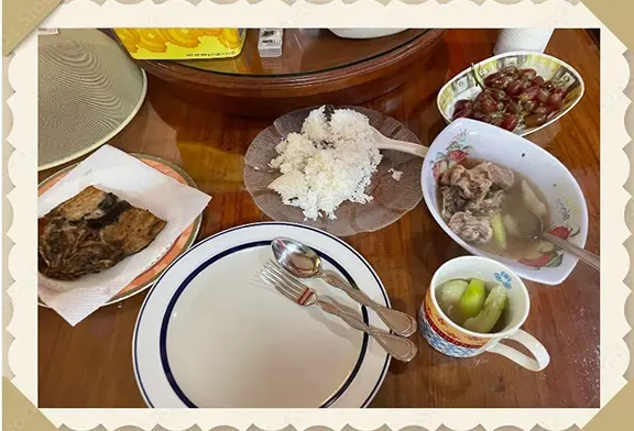 Traditional meal with rice, fish, and soup.