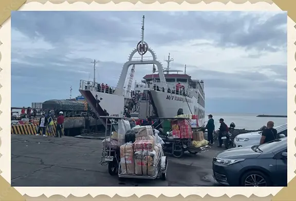 Ferry loading cargo and passengers at dock.