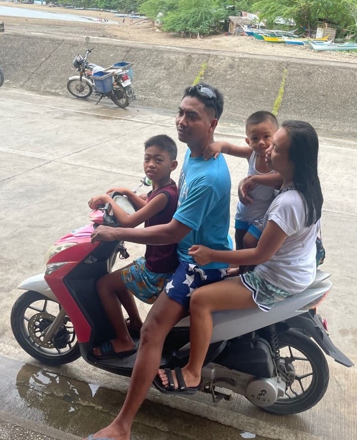 A man and three children on a motorcycle.