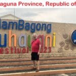 A man standing in front of a sign for the guam bagong buhainimi festival.