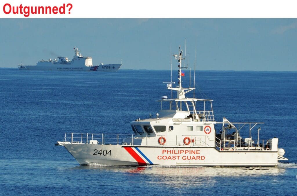 A coast guard boat in the ocean with two other boats.