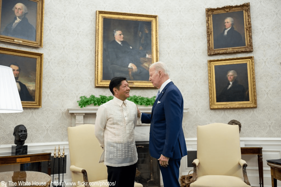 A man in a suit and tie standing next to another man.