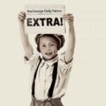 A young boy holding up an extra sign.