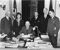 A group of people standing around a table.