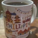 A coffee mug with the word philippines written on it.